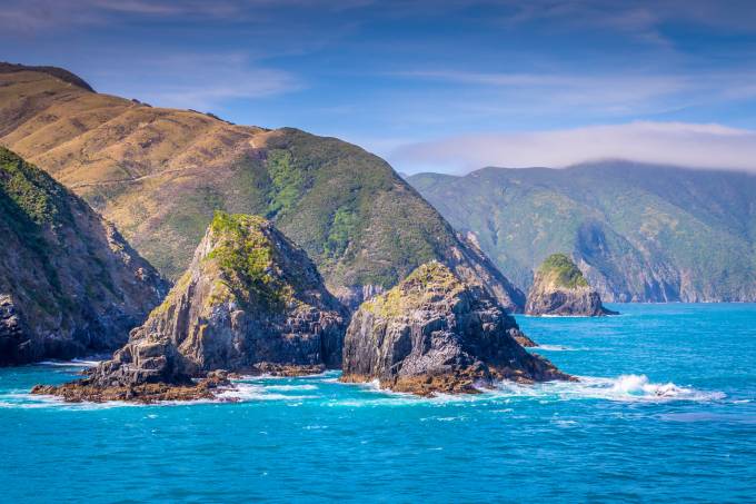 Cook Strait, New Zealand: View from the ferry that crosses between the North and the South Island entering the Marlborough Sound. The rocky cliffs tease the spectacular landscapes of the South Island. (Photo: Shutterstock)