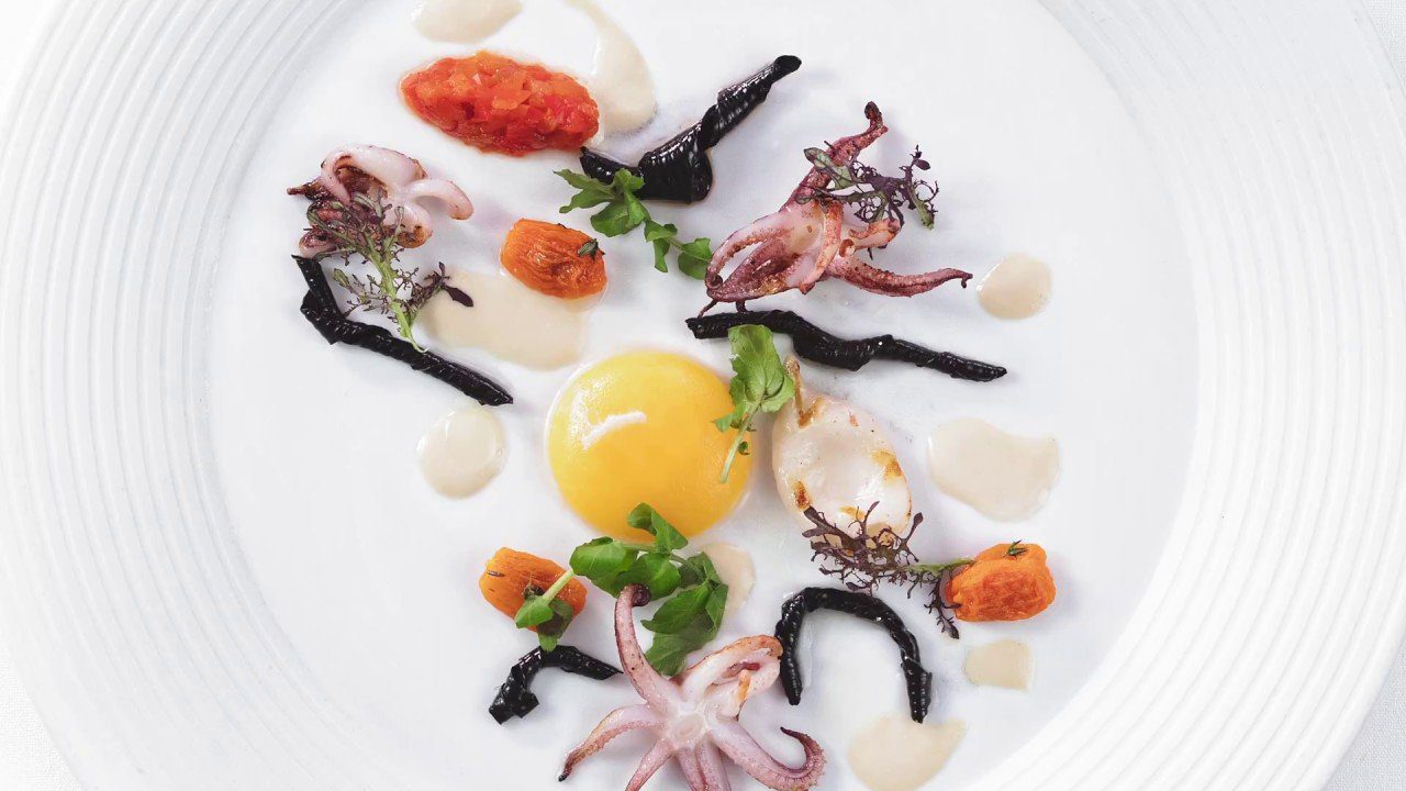 A white plate with an octopus on it.