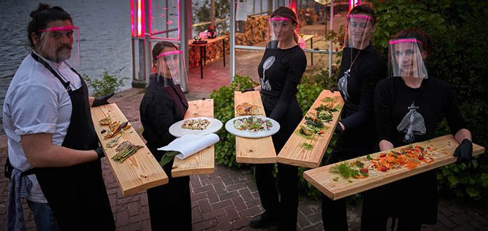 Long planks and PPE clad staff offer a glimpse into a post corona dining experience (Photo: Mediamatic/Willem Velthoven)