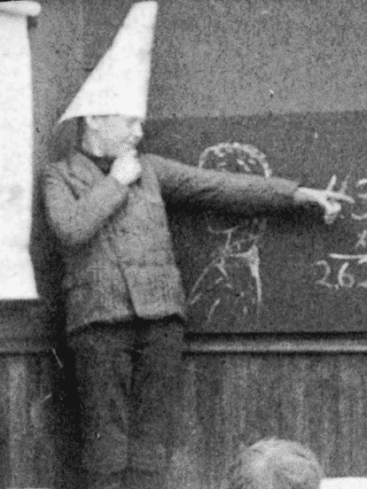 Boy standing in the Dunces corner circa 1906 (Photo: Wikimedia/Underwood & Underwood)