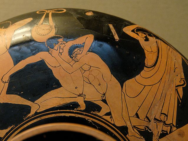 Pankration scene: the pankriatiast on the right tries to gouge his opponent's eye; the umpire is about to strike him for this foul. (Photo: Wikimedia/British Museum)