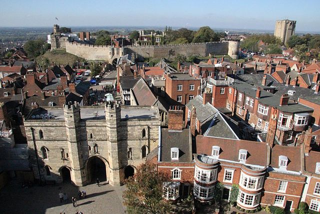 The view west from Lincoln Cathedral of Lincoln Castle. On the left hand side of the castle the 'Lucy Tower' on top of one of the castle's two keeps can be seen. To the right of that the the east gatehouse, and two towers can be seen further to the right.