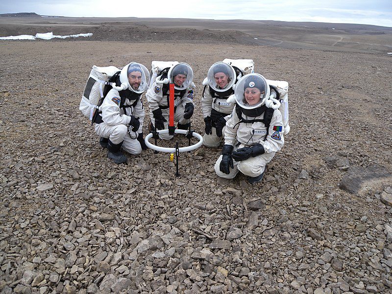 FMARS 2009 crew members Brian Shiro, Christy Garvin, Stacy Cusack and Kristine Ferrone deploy the TEM47-PROTEM low frequency electromagnetic survey equipment on Haynes Ridge during EVA 8. This was in close proximity to the Flashline Mars Arctic Research Station (FMARS) on Devon Island, Nunavut, Canada.